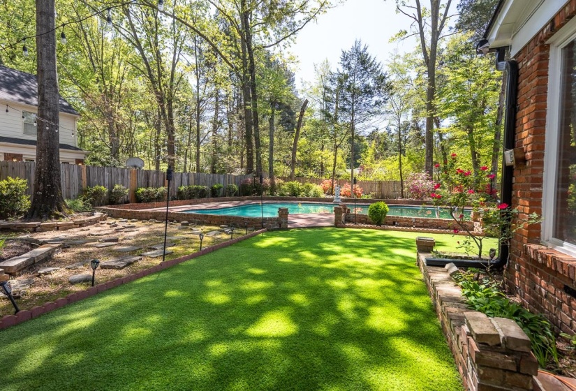 Fenced backyard with a patio