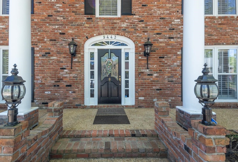 View of exterior entry with brick siding
