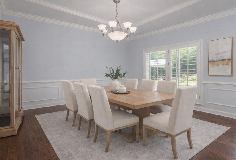 Dining room with a decorative wall, dark wood finished floors, a chandelier, wainscoting, and ornamental molding