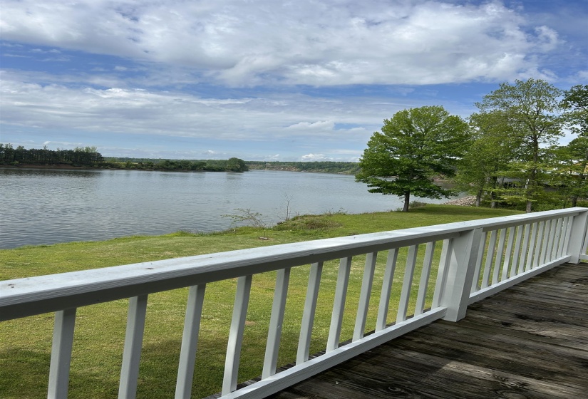 Wooden deck featuring a yard and a water view Wooden deck featuring a yard and a water view