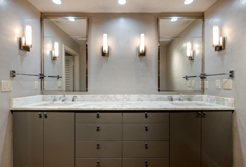 Full primary bathroom with double vanity and recessed lighting