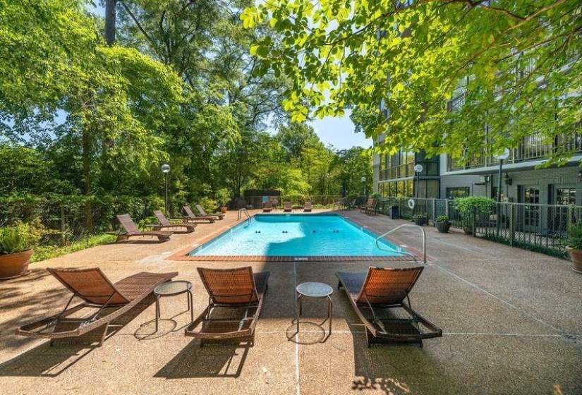 Community pool with fence and a patio area