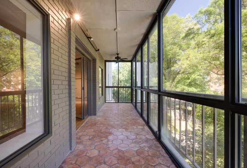 Unfurnished sunroom featuring two ceiling fan