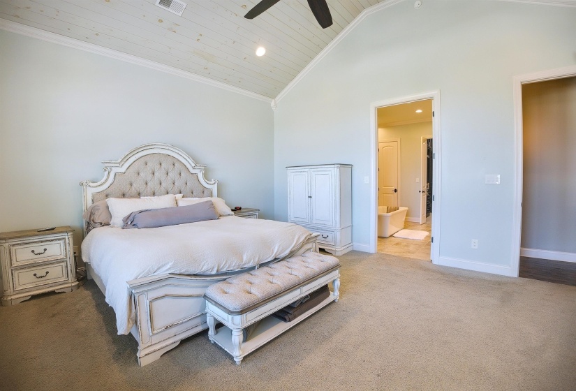 Bedroom with baseboards, carpet flooring, wood ceiling, and high vaulted ceiling