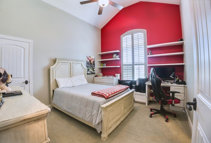 Bedroom featuring high vaulted ceiling, light carpet, and a ceiling fan