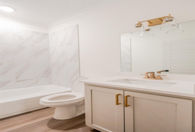 Full bathroom featuring vanity, shower / washtub combination, and light wood-type flooring