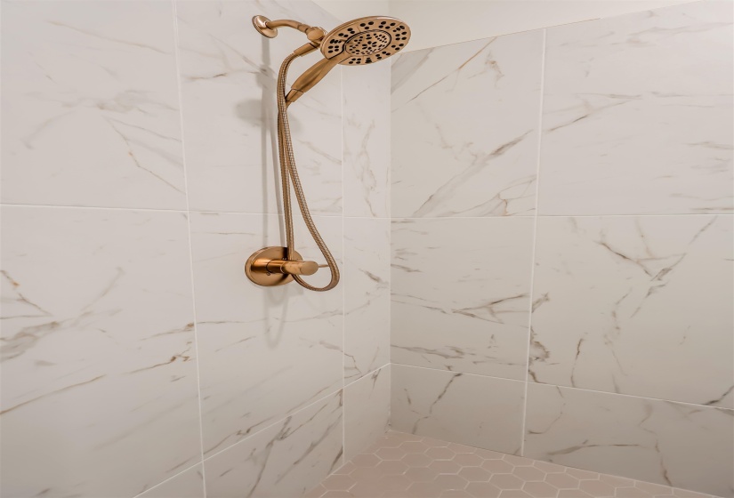 Bathroom view of a marble finish shower