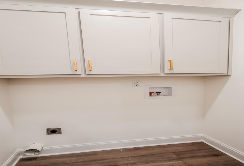 Washroom featuring cabinet space, dark wood-style floors, washer hookup, and hookup for an electric dryer