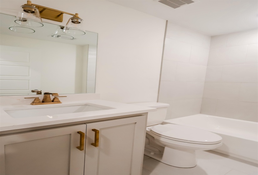 Bathroom with vanity, tile patterned flooring, and  shower combination