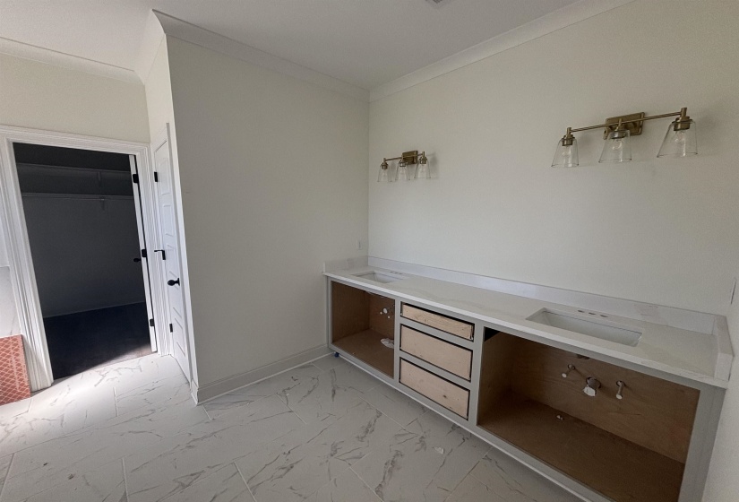 Mudroom with light marble finish flooring and crown molding