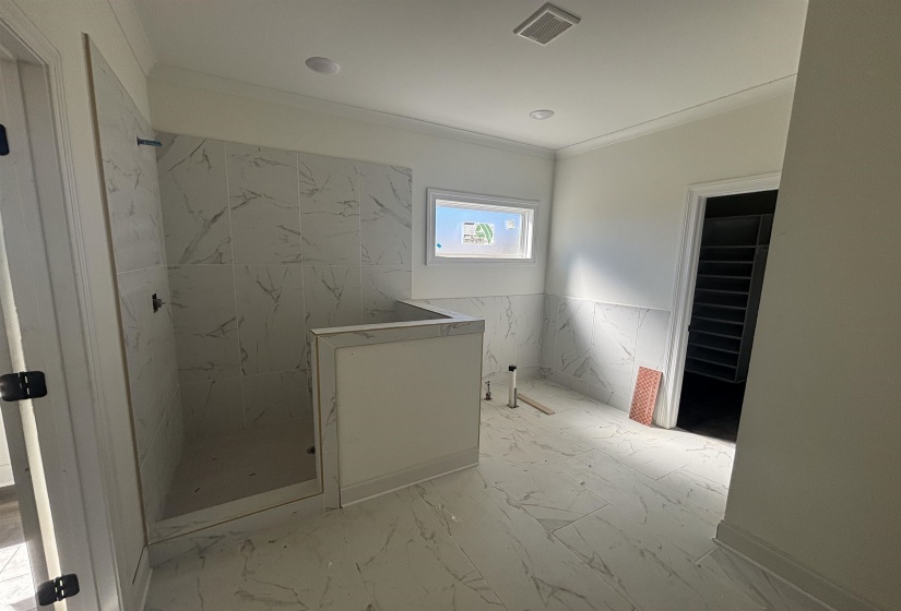 Full bathroom featuring a marble finish shower, light marble finish floors, and crown molding