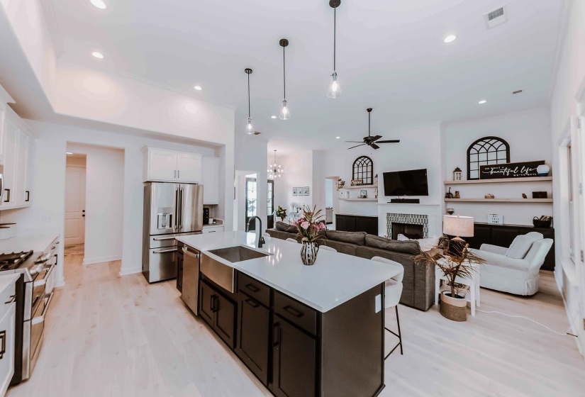 Kitchen featuring a ceiling fan, visible vents, a sink, stainless steel appliances, and white cabinetry