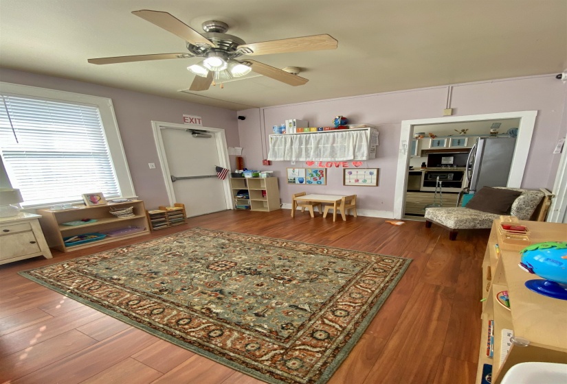 Living room featuring ceiling fan and wood finished floors