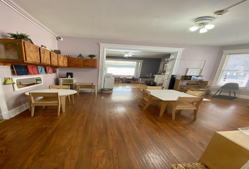 Dining space featuring plenty of natural light, a ceiling fan, and dark wood-style floors