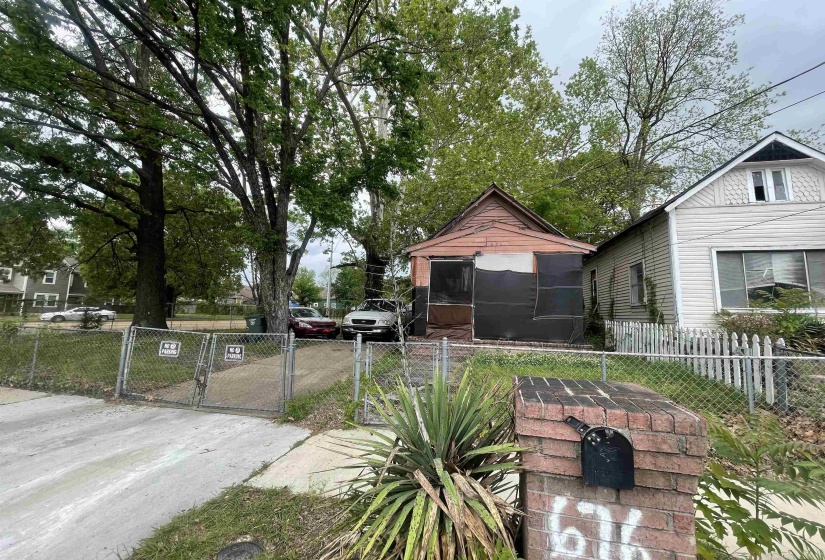 View of front facade with fence private yard and a gate