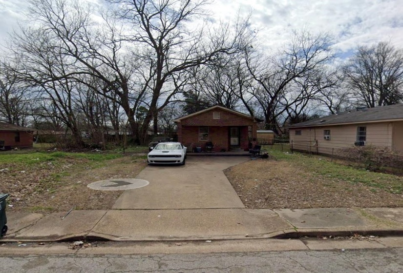 View of side of home featuring fence and concrete driveway