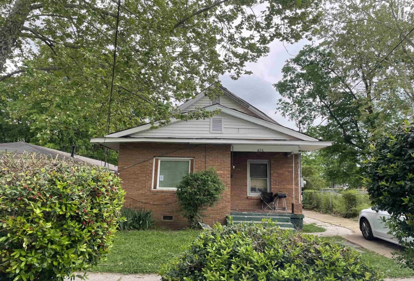 Bungalow-style home with brick siding, crawl space, and a porch