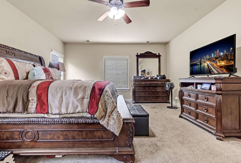 Bedroom featuring light carpet and ceiling fan