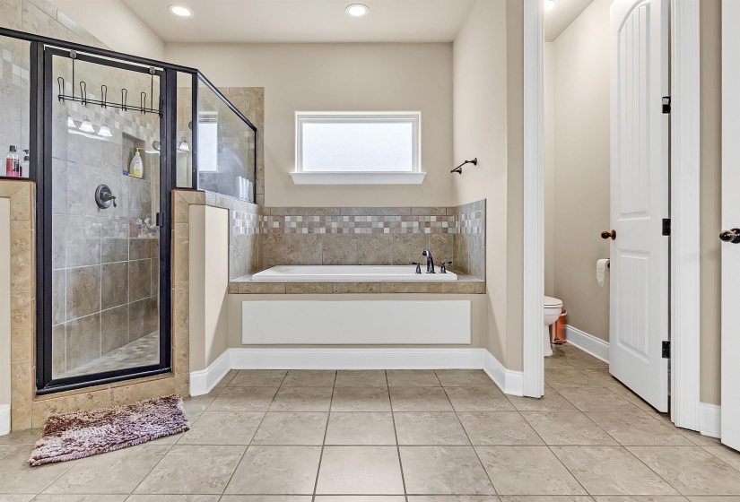 Bathroom featuring toilet, recessed lighting, tile patterned flooring, a shower stall, and a bath