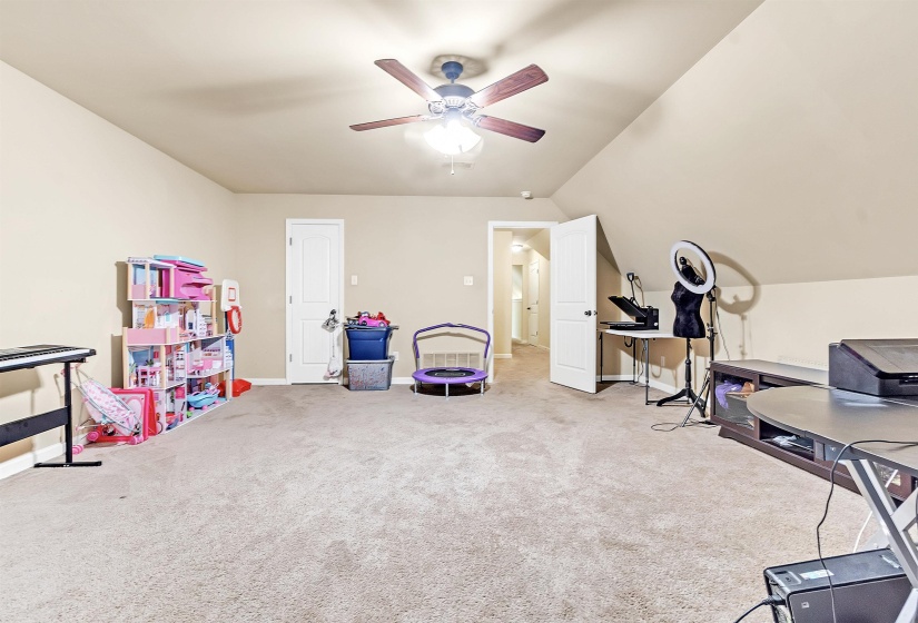 Game room featuring vaulted ceiling, ceiling fan, carpet flooring, and baseboards