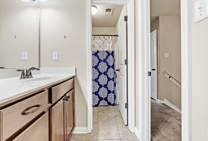 Bathroom featuring baseboards, tile patterned floors, vanity, and visible vents