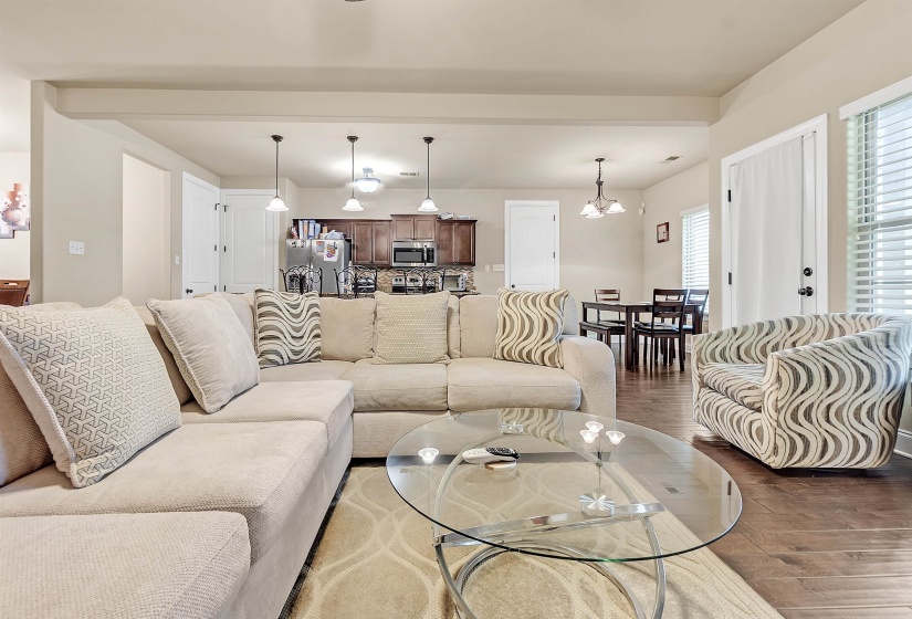 Living room with a notable chandelier and wood finished floors