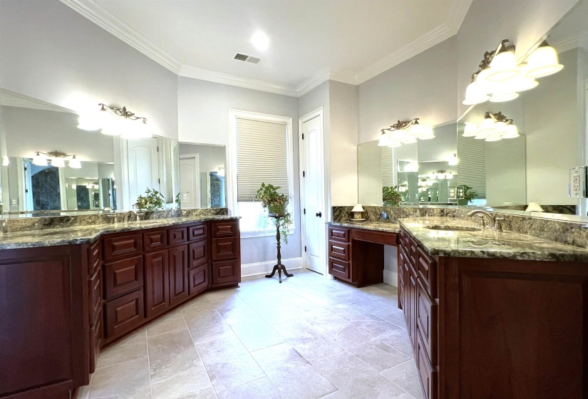 Full bathroom featuring two vanities and crown molding