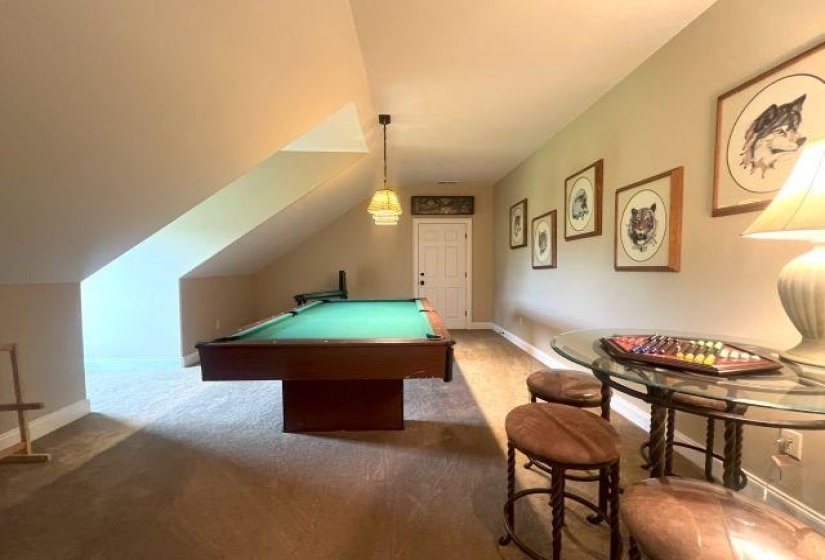 Recreation room with baseboards, carpet flooring, pool table, and lofted ceiling