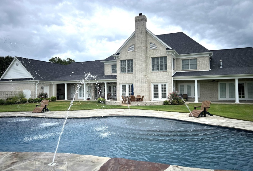 Outdoor pool featuring a yard and a patio area