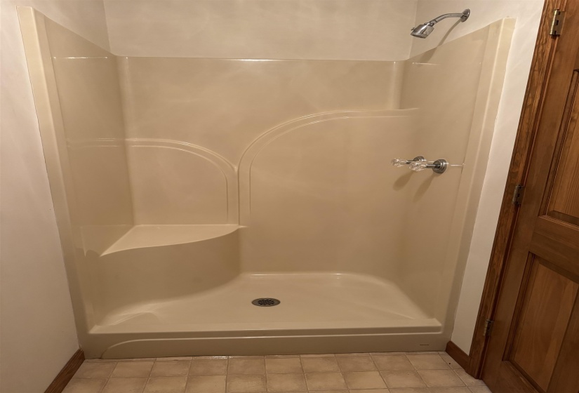 Bathroom with baseboards and a shower