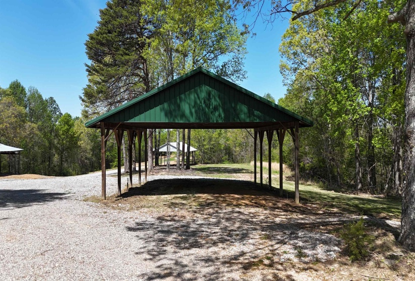 View of community with gravel driveway and a detached carport