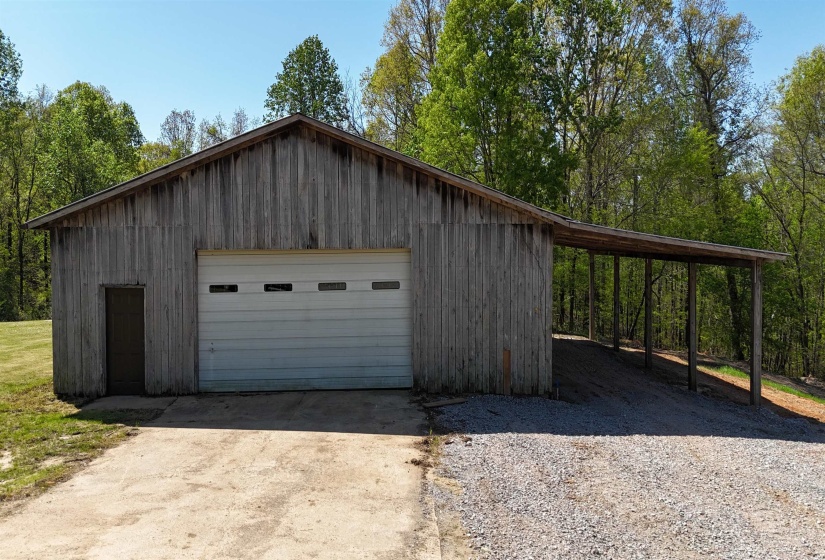 Garage featuring driveway and a detached garage