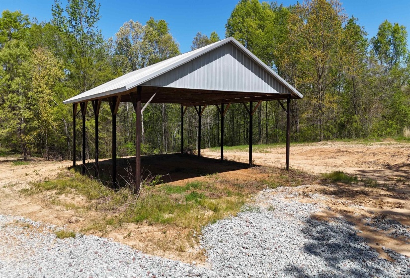 Exterior space with a forest view and a carport