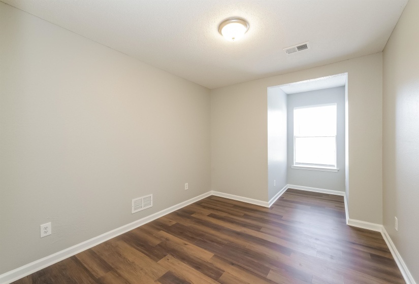 Empty room with dark wood-type flooring