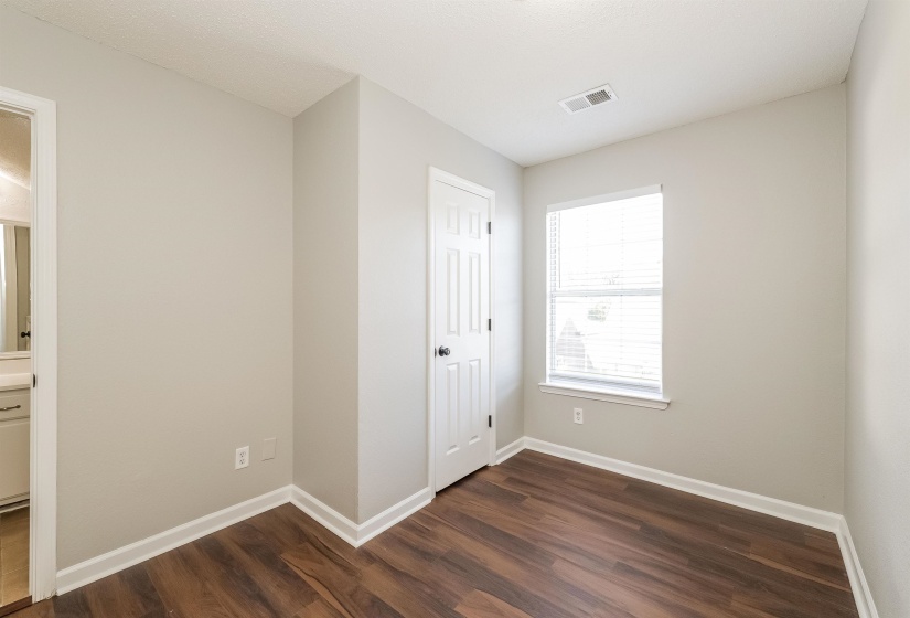 Unfurnished bedroom featuring a closet and dark hardwood / wood-style flooring