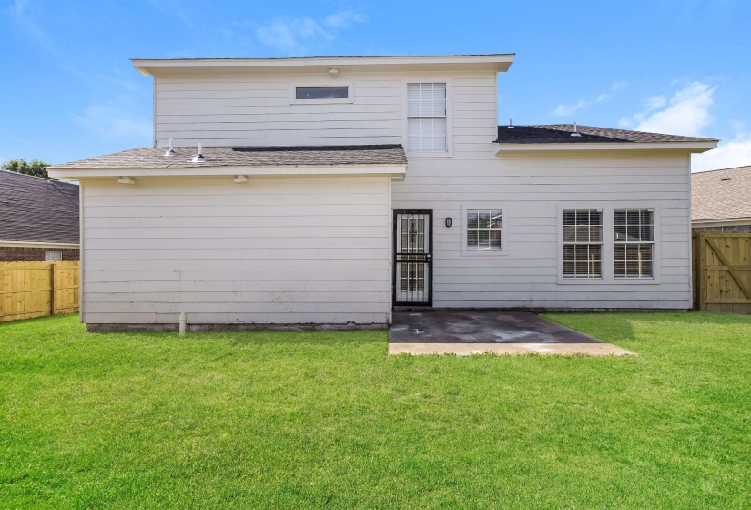 Rear view of property with a patio area and a yard