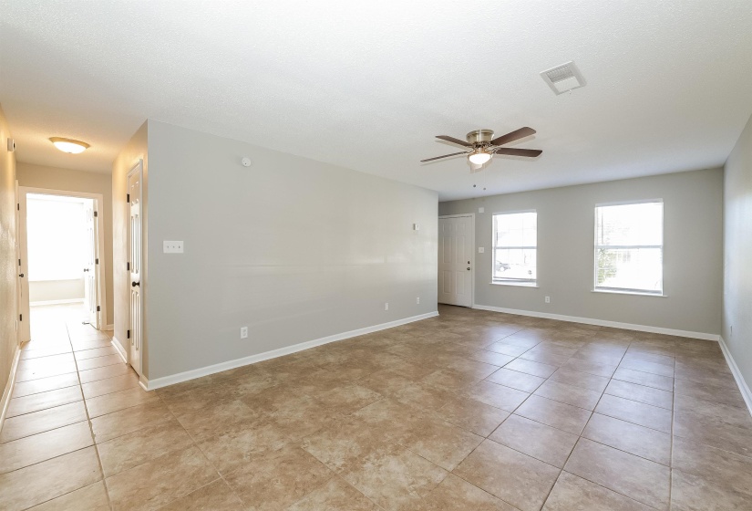Tiled empty room with ceiling fan