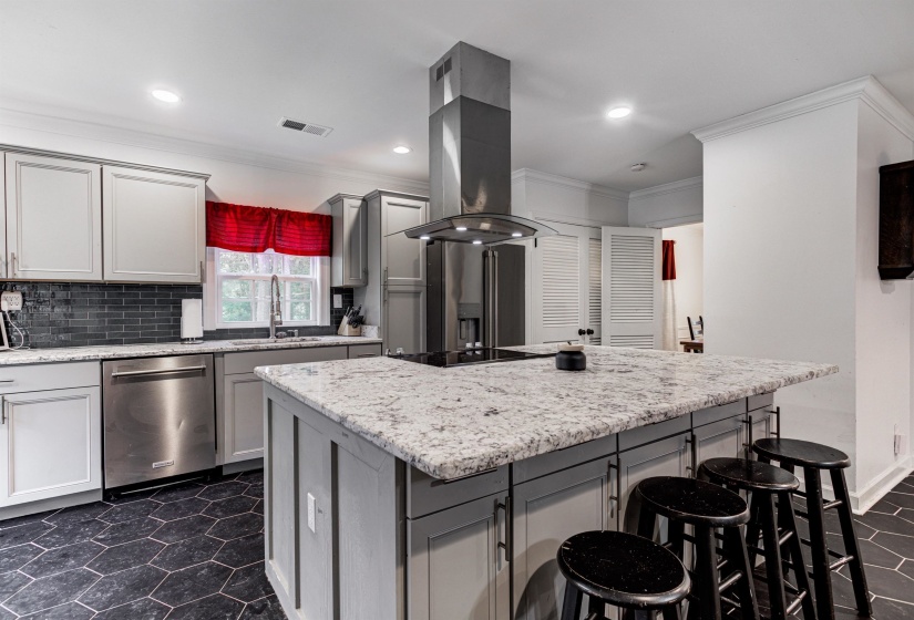Kitchen with stainless steel dishwasher, a sink, island exhaust hood, crown molding, and a kitchen island