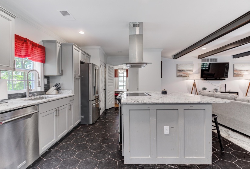 Kitchen featuring appliances with stainless steel finishes, a sink, gray cabinets, island range hood, and crown molding