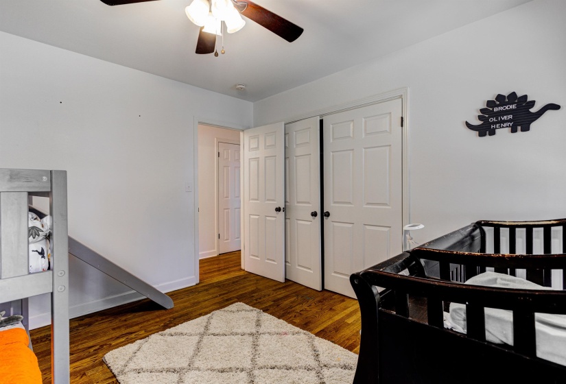 Bedroom with wood finished floors, a closet, ceiling fan, and baseboards