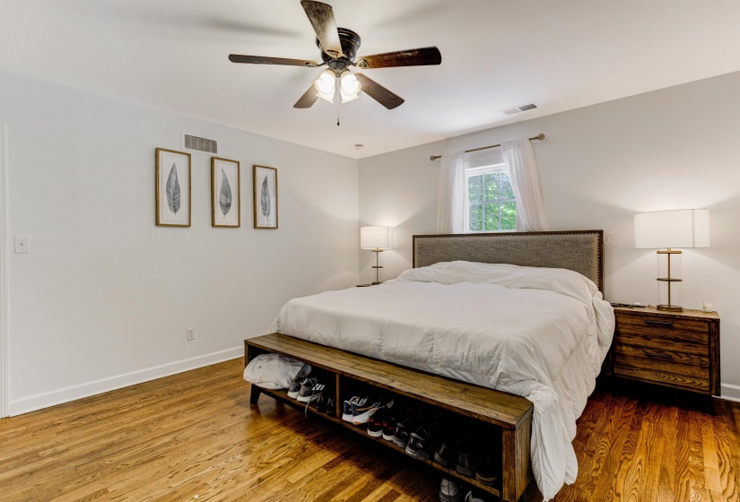 Bedroom with baseboards, wood finished floors, and a ceiling fan