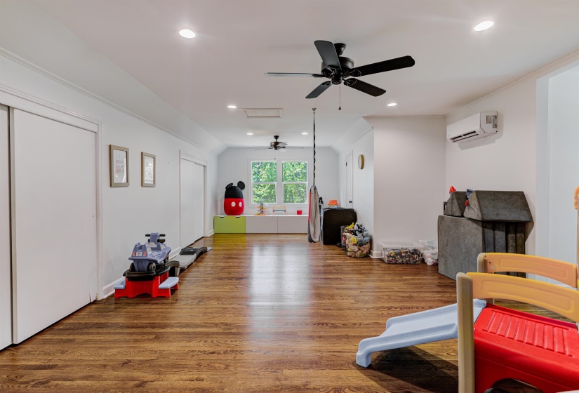 Rec room with a ceiling fan, wood finished floors, a wall mounted AC, and recessed lighting