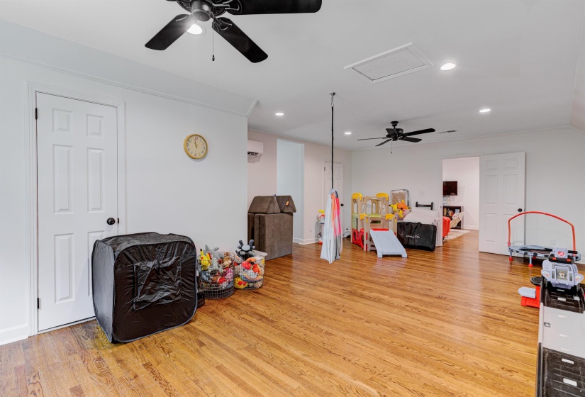 Game room with a ceiling fan, light wood-style floors, attic access, and recessed lighting