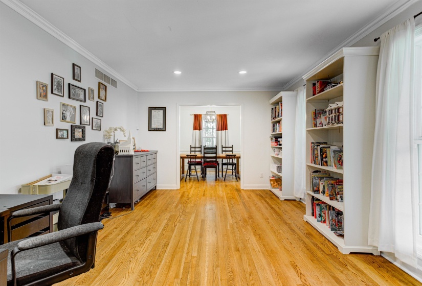 Home office featuring light wood-type flooring, crown molding, recessed lighting, and baseboards