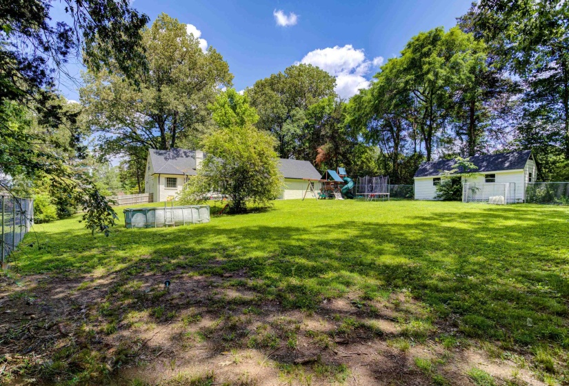 View of yard featuring a playground and an outdoor structure