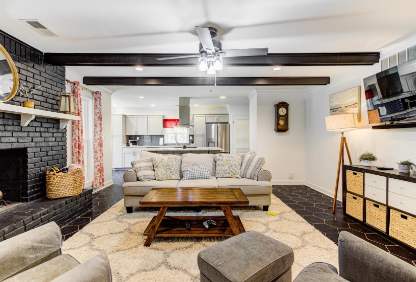 Living area with beamed ceiling, a ceiling fan, baseboards, recessed lighting, and a fireplace