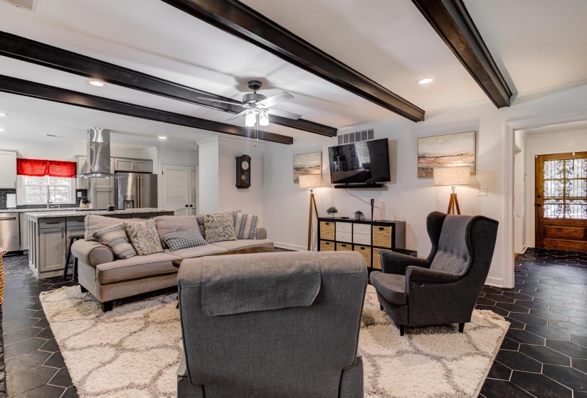 Living room with healthy amount of natural light, recessed lighting, baseboards, beamed ceiling, and a ceiling fan