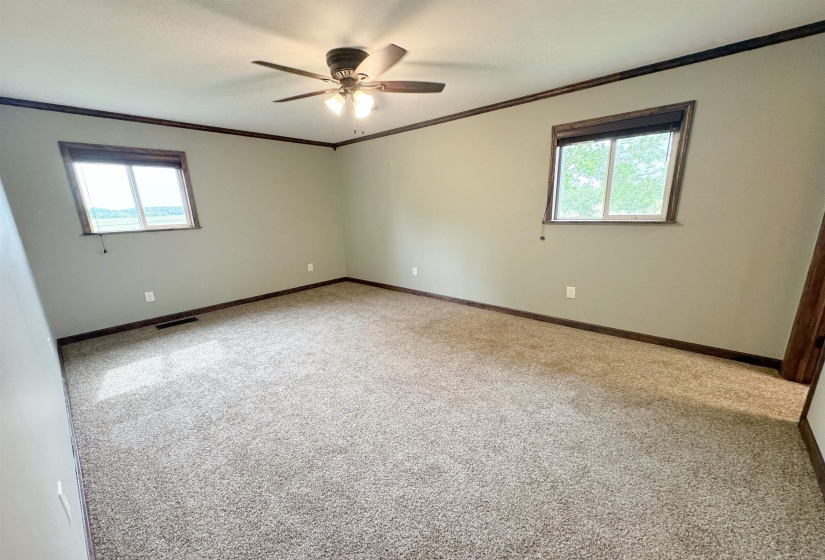 Unfurnished room with ornamental molding, ceiling fan, carpet floors, and baseboards