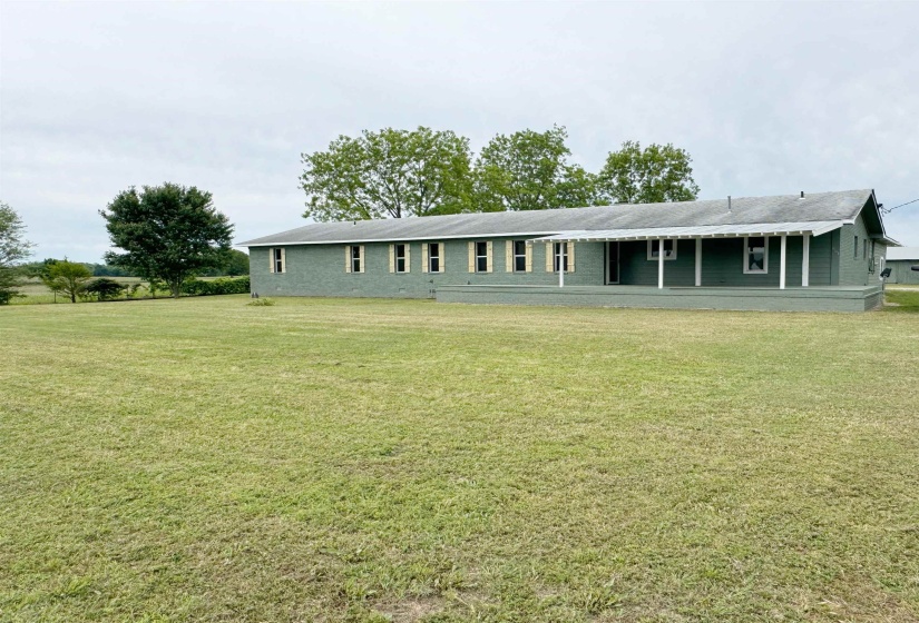 Back of house featuring a lawn