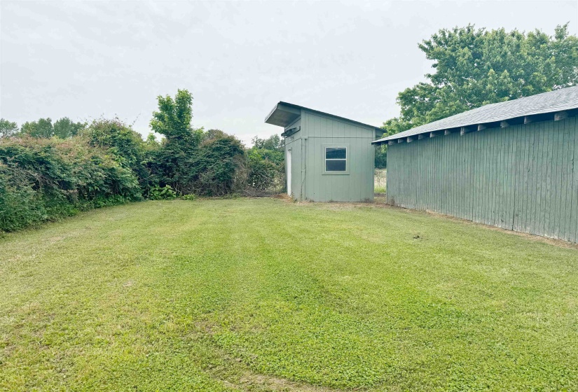 View of grassy yard featuring an outdoor structure